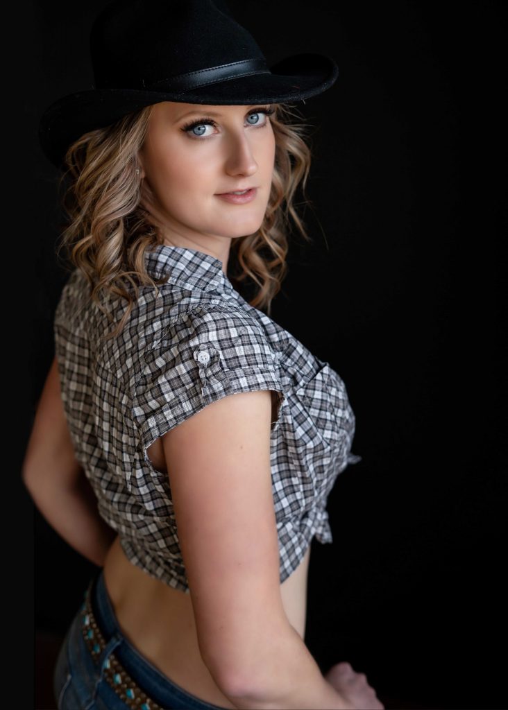 Women posing in cowboy hat for boudoir shoot in Victoria BC photography studio.