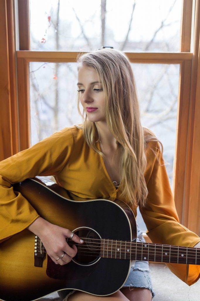 Portrait of girl playing guitar. 