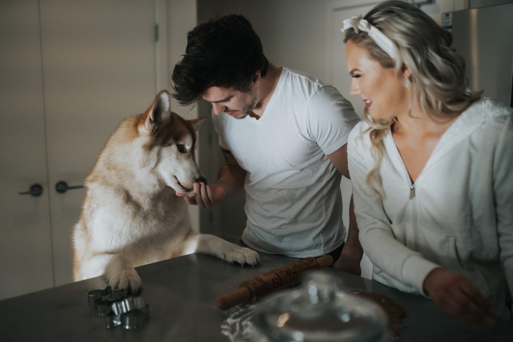 Couple and their dog baking