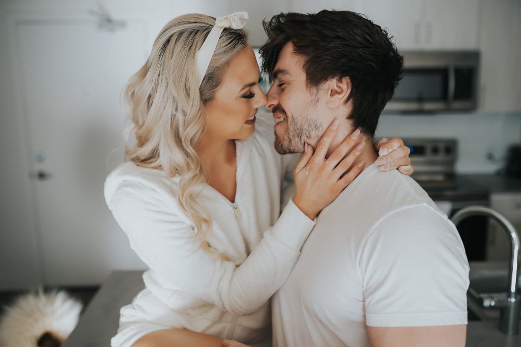 Couple wearing white kissing