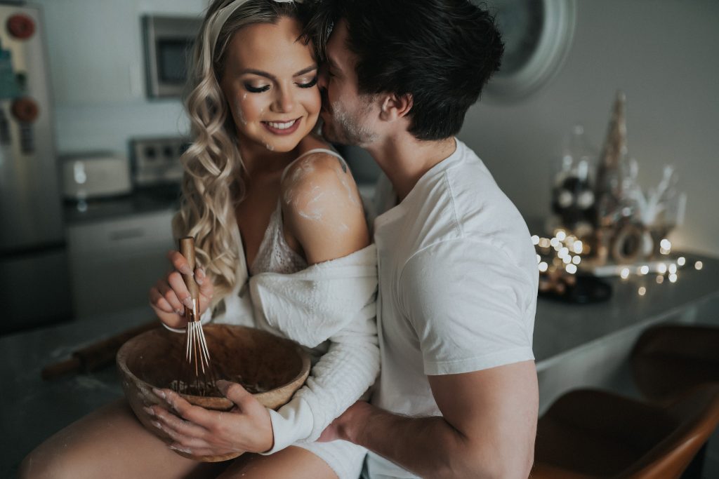 Couple cuddling with mixing bowl