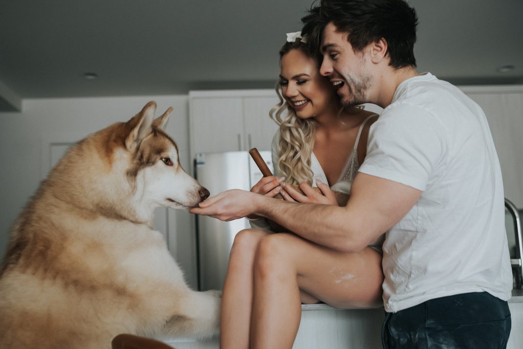 Models laughing and petting dog