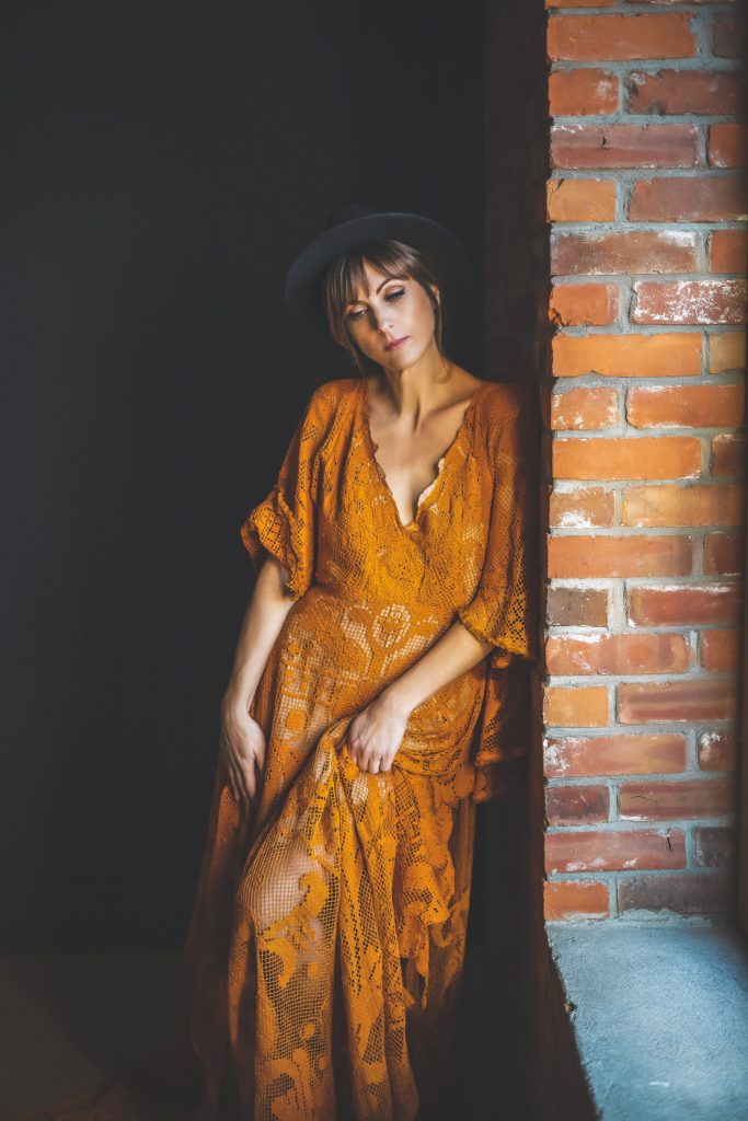 Woman posing in bohemian dress by Reclamation Design