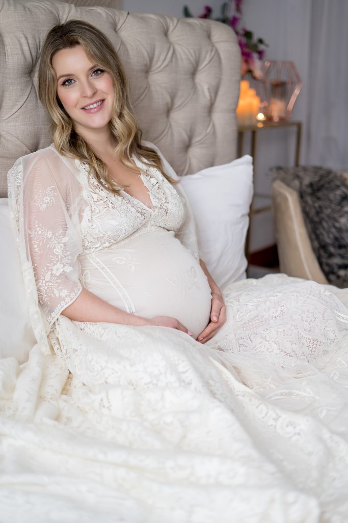 blond woman posing for boudoir maternity session
