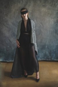 female model posing in black and white dress for fashion shoot