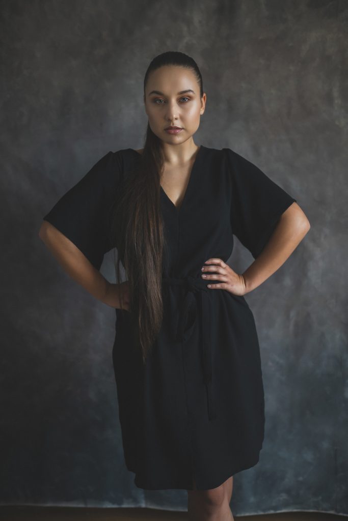 woman modelling black dress