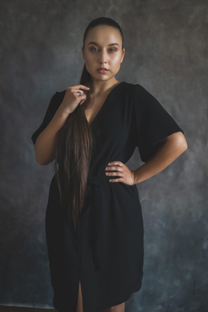woman modelling black dress