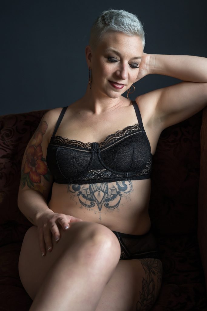 Woman with short white hair posing in black lingerie for over 40 boudoir session