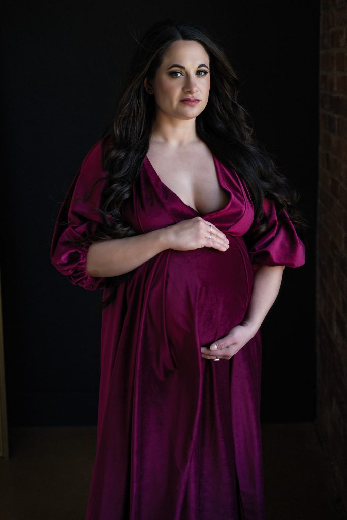 pregnant woman wearing red velvet gown