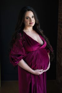 pregnant woman wearing red velvet gown