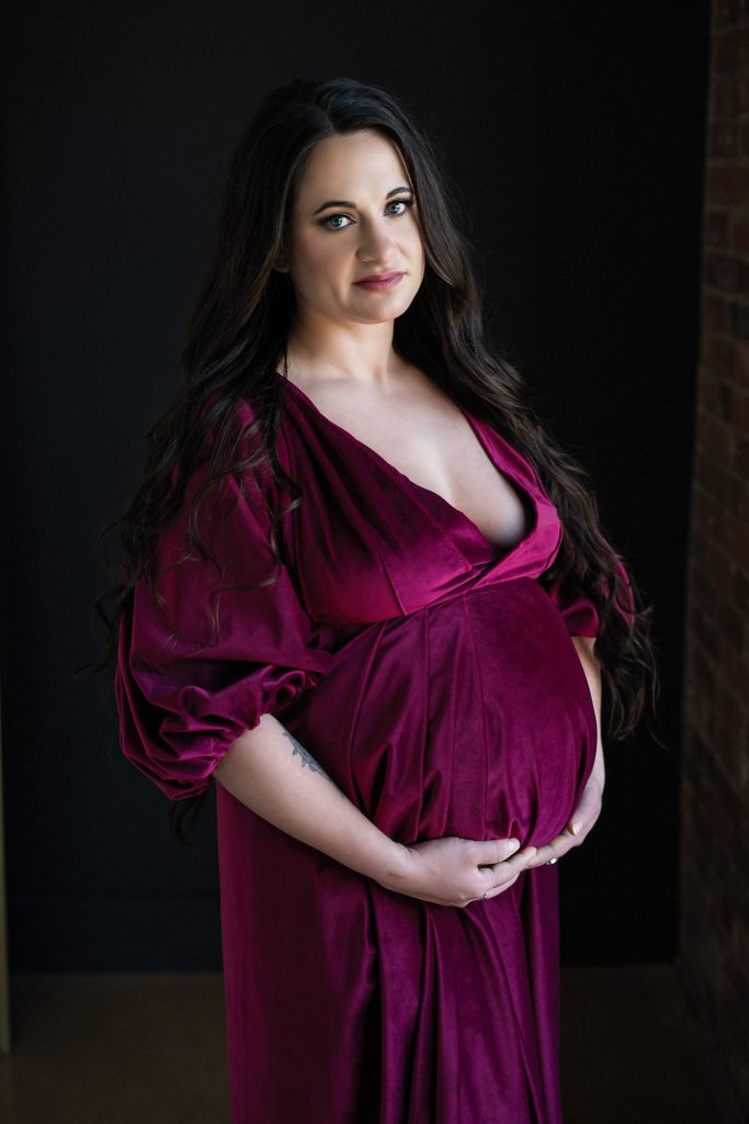 pregnant woman wearing red velvet gown 